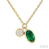 5x3 MM Oval Cut Emerald and 1/50 Ctw Bezel Set Round Cut Diamond Precious Pendant With Chain in 10K Yellow Gold